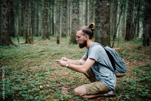 Young bearded man exploring nature photo