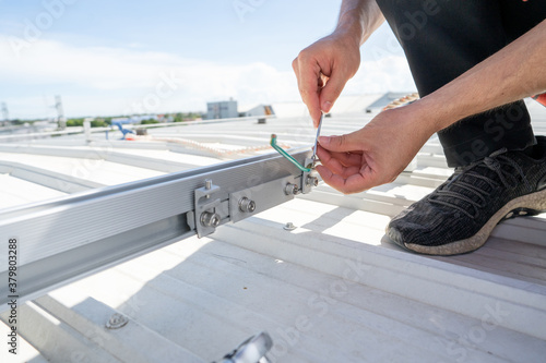 installing grounding in steel bar of solar rooftop power system by barehanded stock photo photo