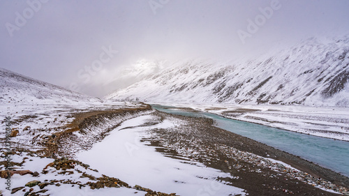 Snow covered beautiful landscape of Chandra river valley in Spiti during winter. Spiti means 'The Middle Land' is a cold desert mountain valley located high in Himalayas of Himachal Pradesh, India.