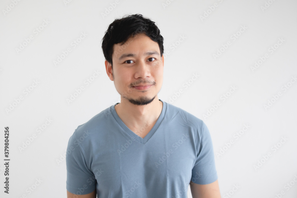 Portrait of happy Asian man in blue t-shirt on isolated white background. Portrait of happy Asian man in blue t-shirt on isolated white background.