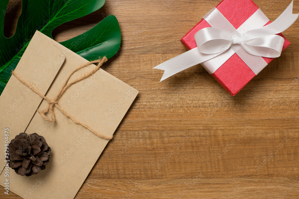Desk with red gift on wooden table top view. Desk with red gift on wooden table top view.