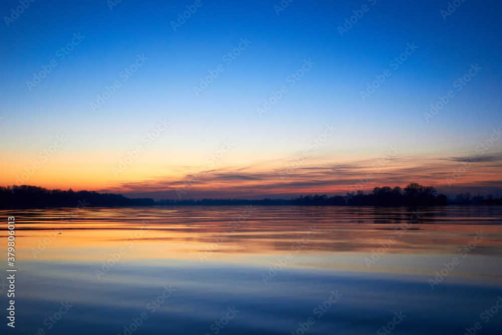 Sunset over the river during the cold season