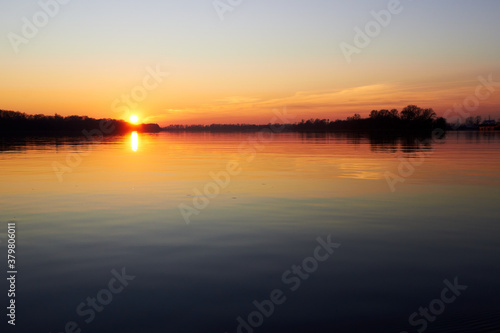 Sunset over the river during the cold season © watcherfox