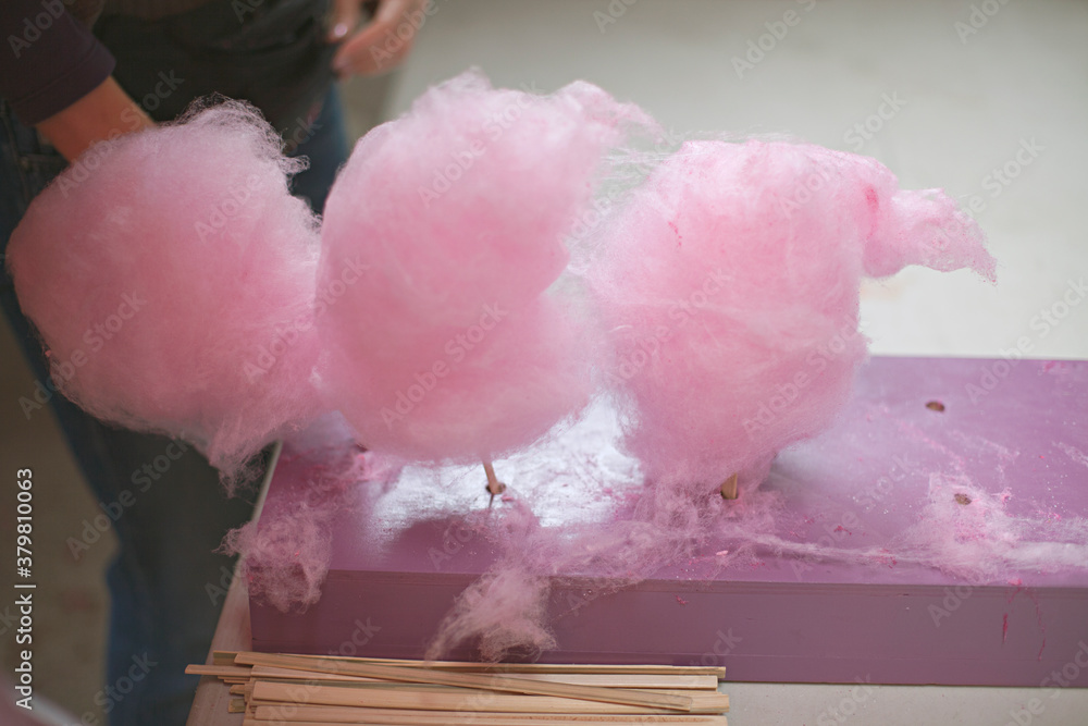 cotton candy / candy floss on table waiting to be sold and eaten cotton candy / candy floss on table waiting to be sold and eaten