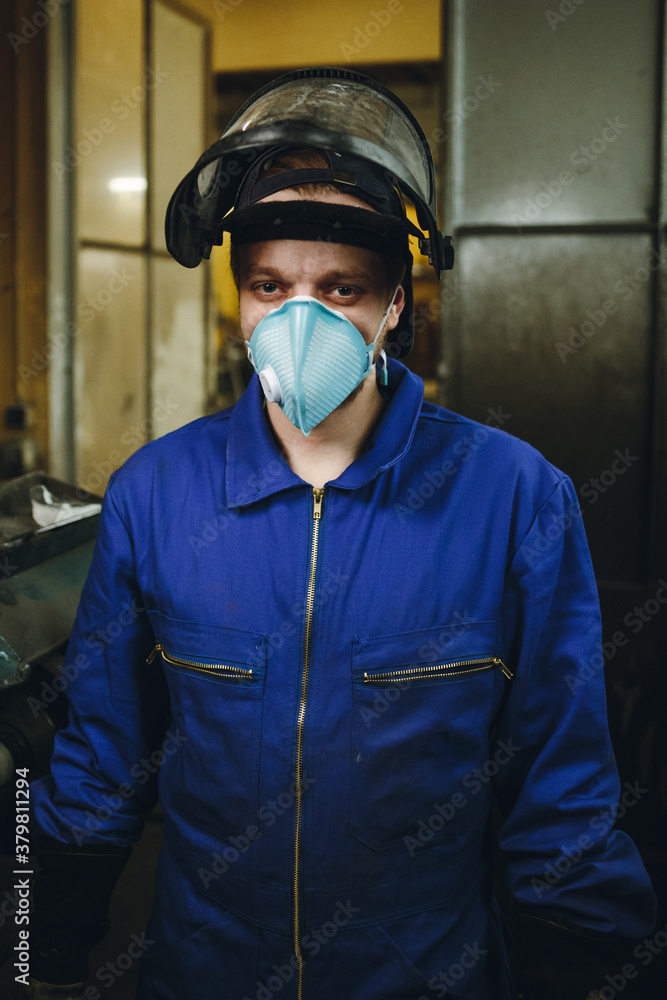 portrait of a metal worker with protection mask in a workshop portrait of a metal worker with protection mask in a workshop