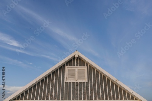 Beautiful characteristic wooden house along the beach side at Costa da Caparica in Lisbon  Portugal. Small village on the beach at sunset facing the Atlantic Ocean  abandoned building on the beach