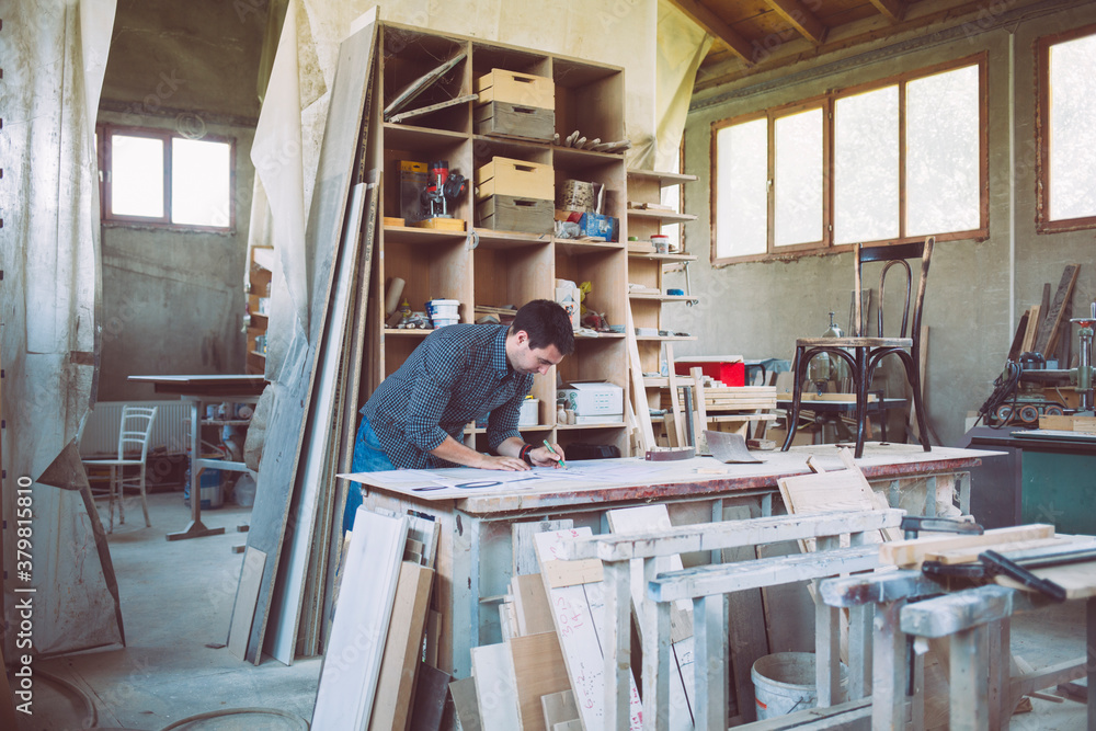 Furniture Designer Working on His Drawings Furniture Designer Working on His Drawings