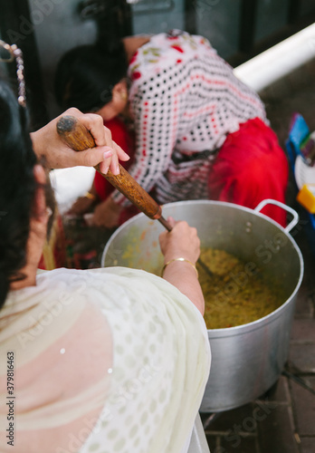 Twp Indian women cooking a large quantity of food photo