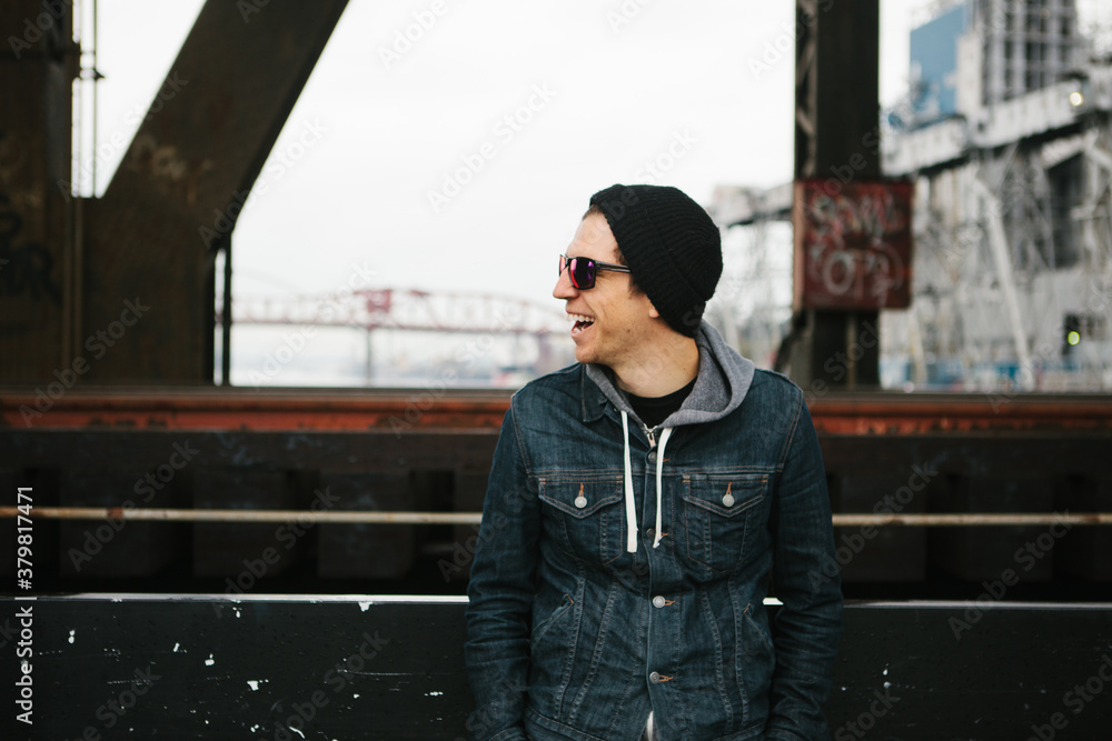 Man wearing a jean jacket standing in an urban setting