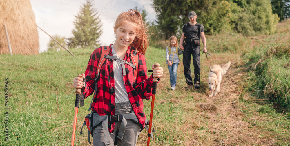 Fototapeta premium Teenage girl trekking in sunny mountains
