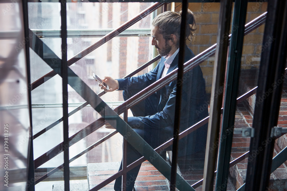 Businessman Using Mobile Phone On Office Steps Businessman Using Mobile Phone On Office Steps