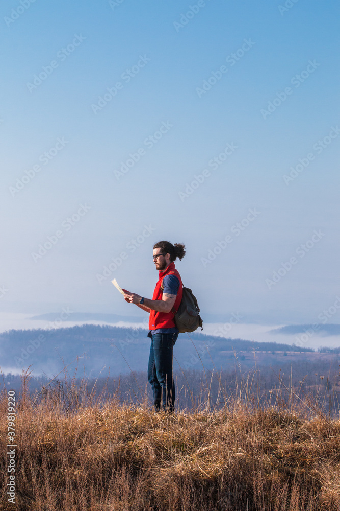 Man Holding A Map While Hiking Man Holding A Map While Hiking