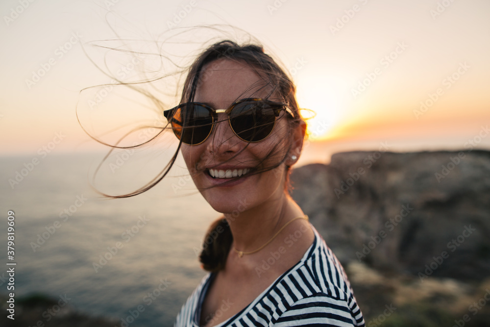 Portrait of a smiling tourist in Algarve coast at sunset. Portrait of a smiling tourist in Algarve coast at sunset.