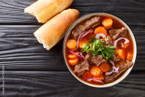 Authentic Vietnamese Beef Stew Bo Kho closeup in bowl on the table. Horizontal top view from above photo