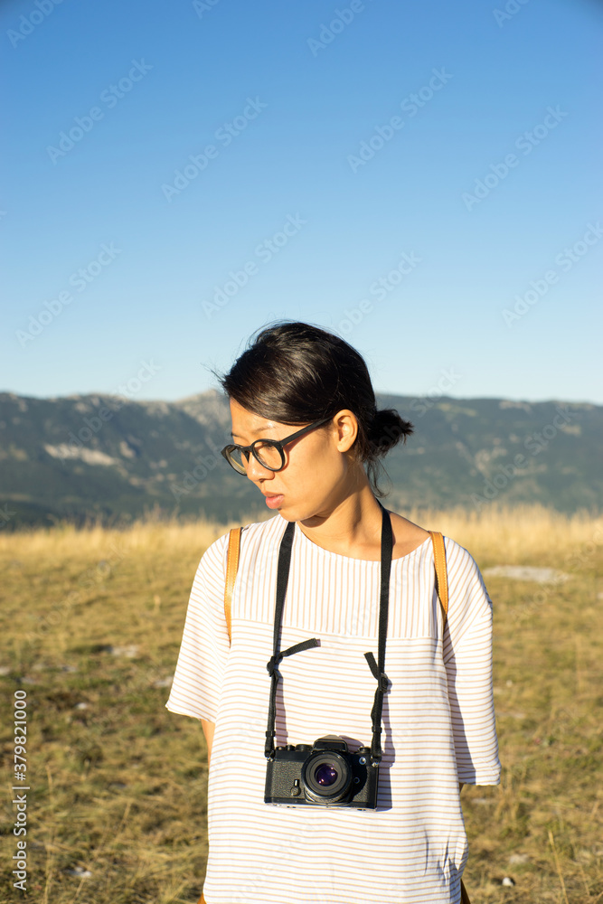 Asian girl holding an old analog camera