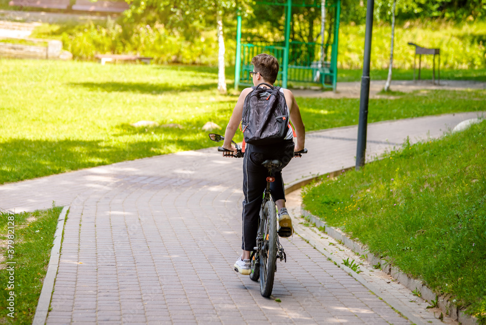 Fototapeta premium Cyclist ride on the bike path in the city Park