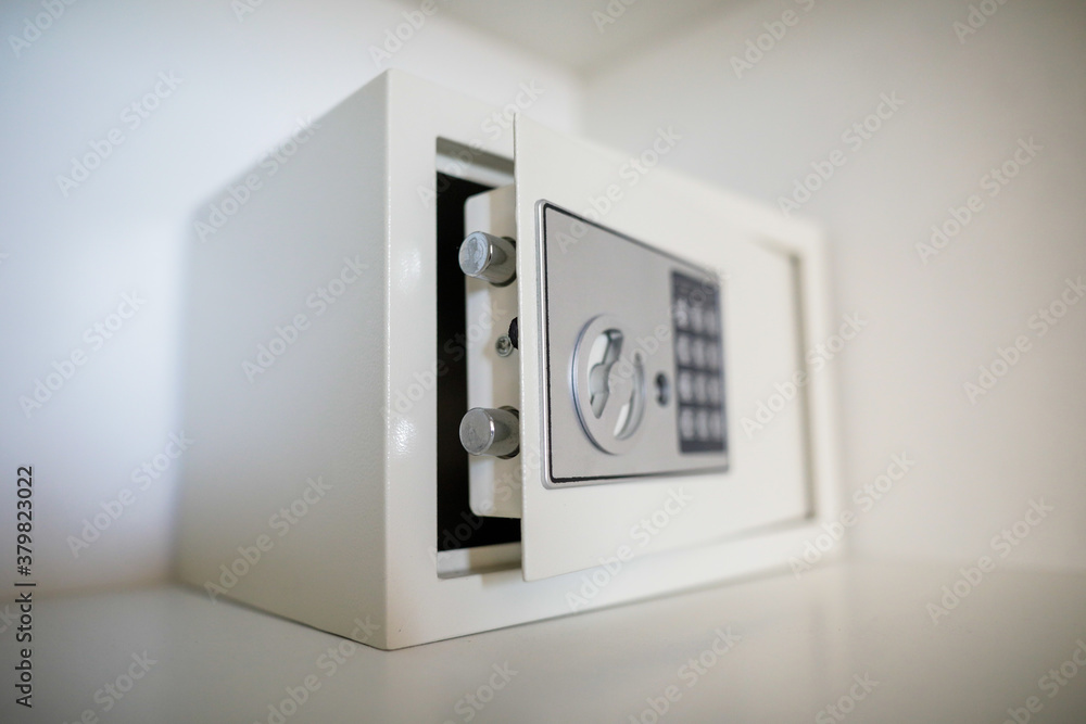 Metal safe inside an empty wooden closet in a hotel room Metal safe inside an empty wooden closet in a hotel room