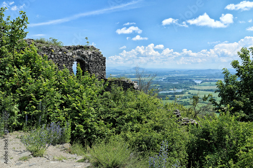 Ruins of castle palace on the hill above Bohemian countryside