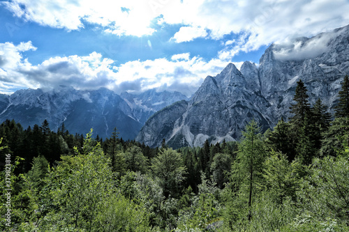 Panorama of Slovenian Alps near Triglav on sunny day with clouds