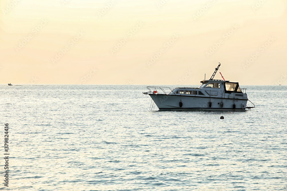 Single boat on the sea in evening light Single boat on the sea in evening light