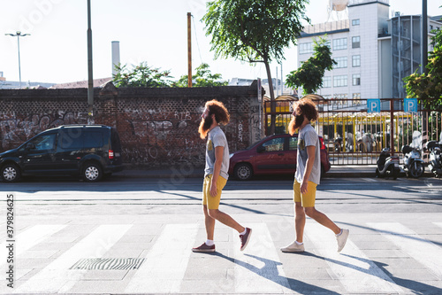 Twins crossing the street