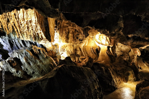 Path inside cave with stone ornaments and cracked walls