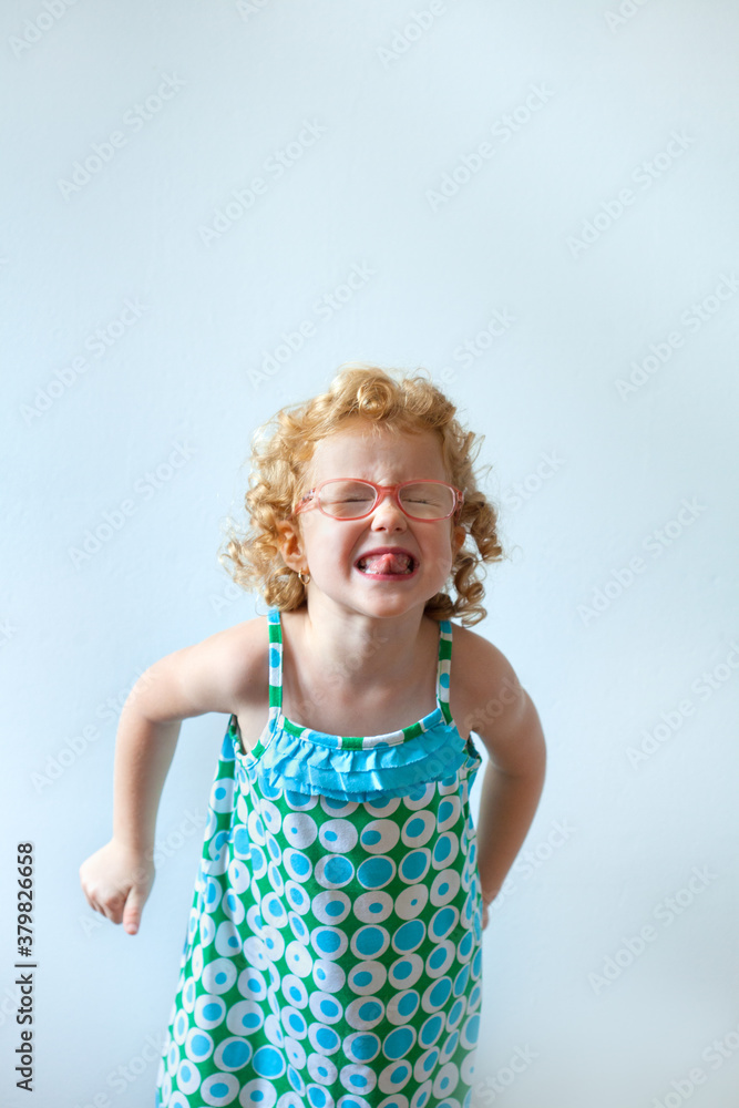 Funny little girl showing grimace Funny little girl showing grimace