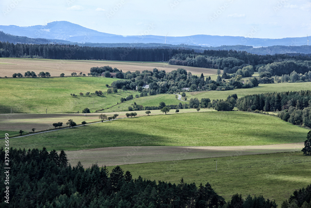 Rural countryside with green pastures roads with trees and forests