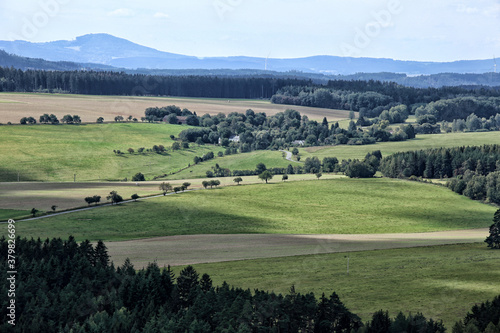 Rural countryside with green pastures roads with trees and forests © ondrejschaumann
