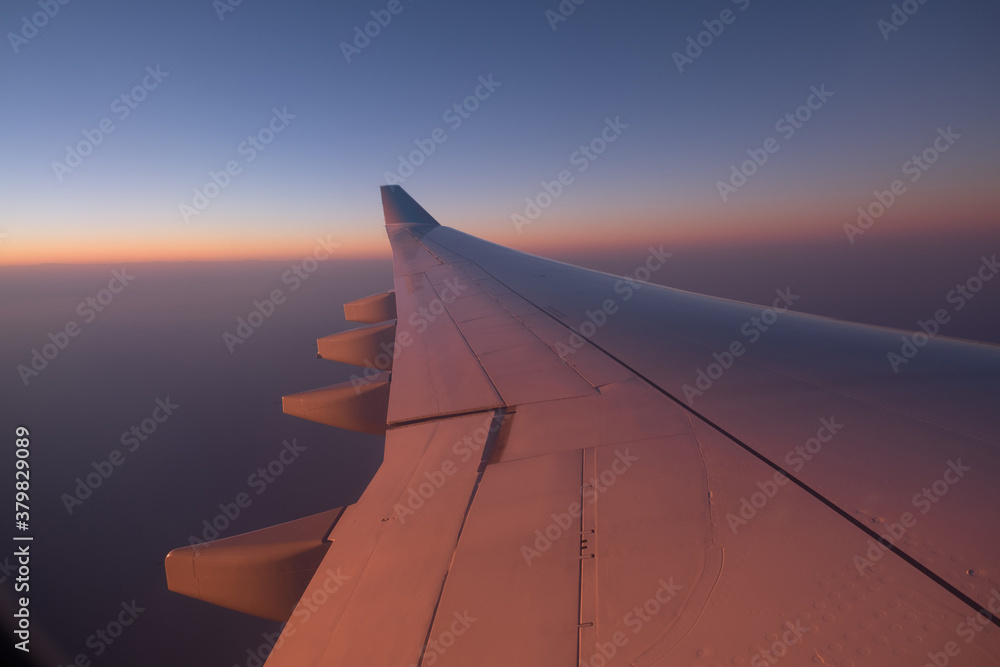 Sunset over the sea, plane wing on frame Sunset over the sea, plane wing on frame