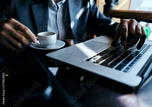 business man in suit in front of laptop with book work communication technology