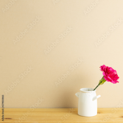 Wallpaper Mural Vase of pink carnation flower on wooden table with beige background Torontodigital.ca