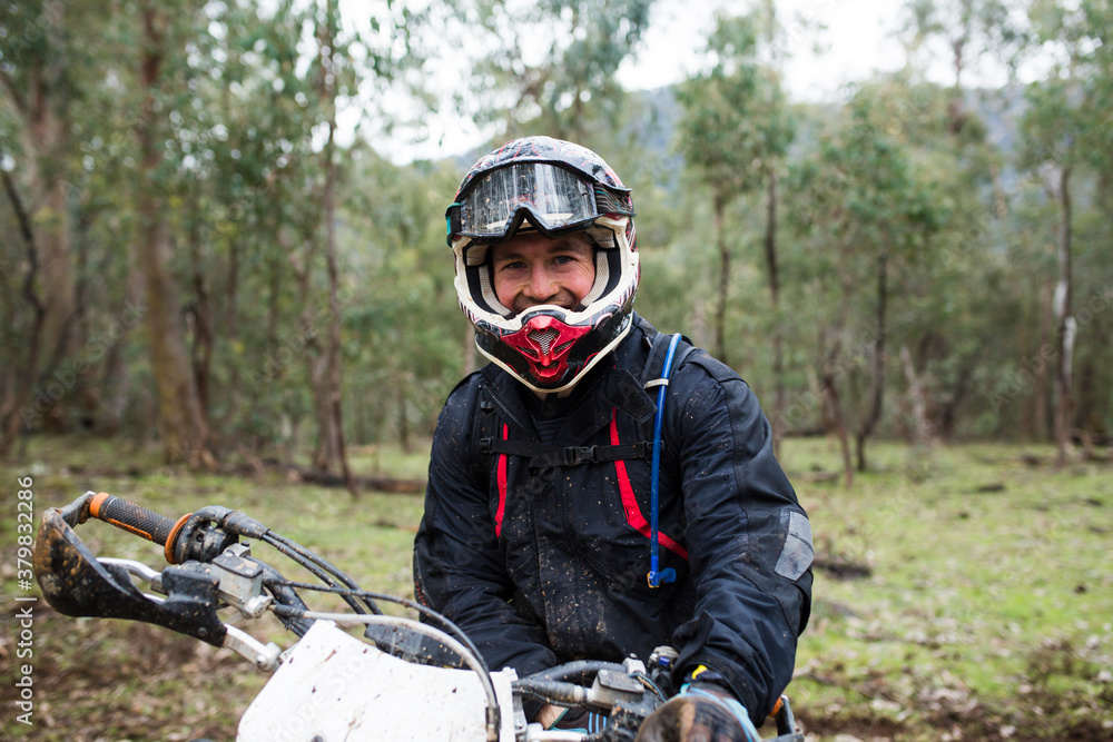 A dirt biker smiling at the camera A dirt biker smiling at the camera