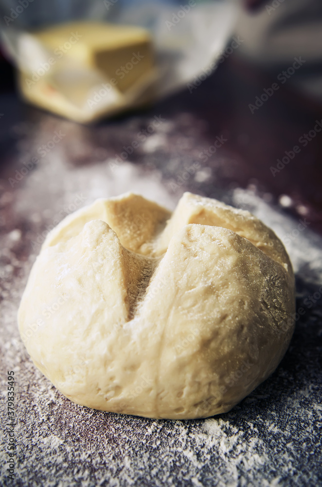 Prepared dough on flouredwooden surface Prepared dough on flouredwooden surface