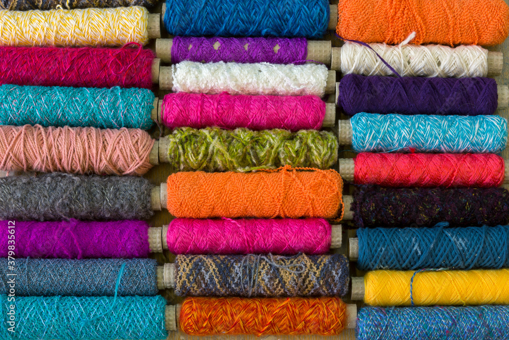 Spindles with different coloured yarn covering the frame Spindles with different coloured yarn covering the frame