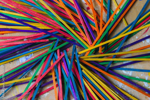 Craft sticks used in a school for art projects arranged in a circle. Vibrant colors photo