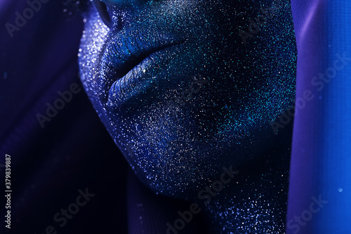 macro lips with blue body art with glitters