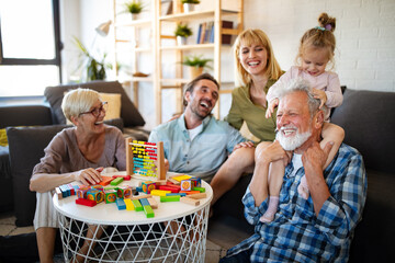 Senior grandparents playing with grandchildren and having fun with family
