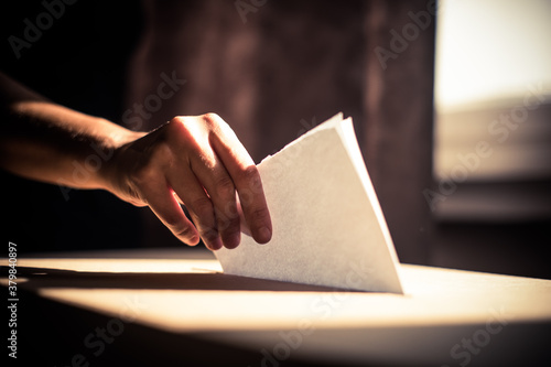 Conceptual image of a person voting during elections photo