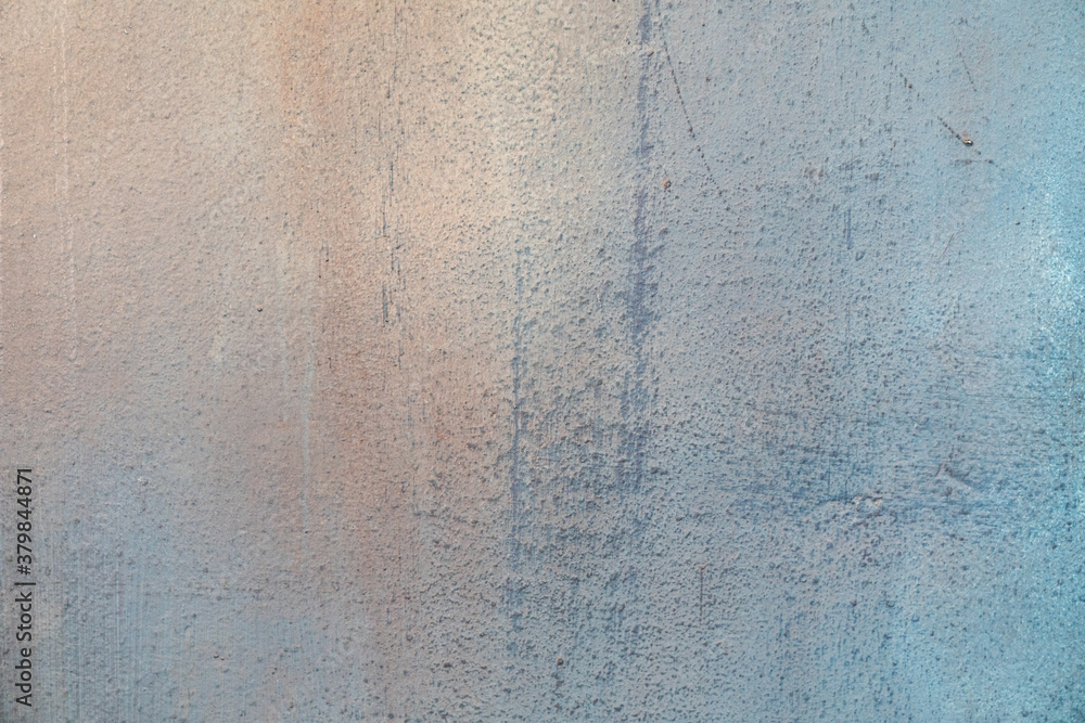 The texture of the wall painted in blue and pink. Uneven rough texture