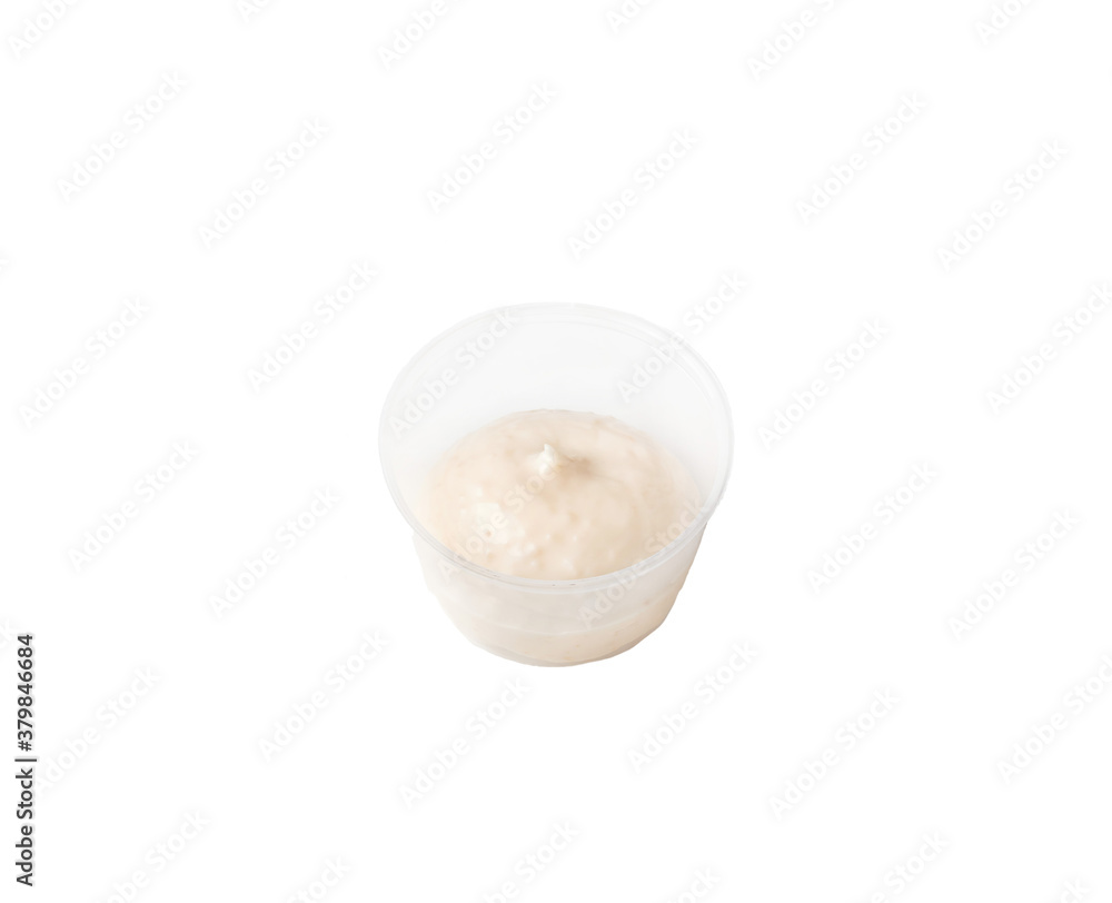 cream sauce in a plastic container on an isolated white background cream sauce in a plastic container on an isolated white background