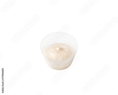 cream sauce in a plastic container on an isolated white background