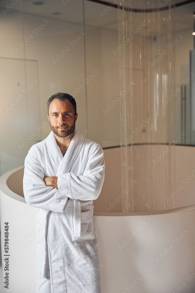 Good-looking young man standing at wellness center Good-looking young man standing at wellness center
