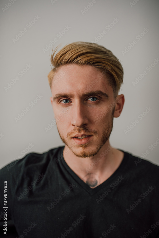 Portrait of a young attractive man in front of the white wall Portrait of a young attractive man in front of the white wall