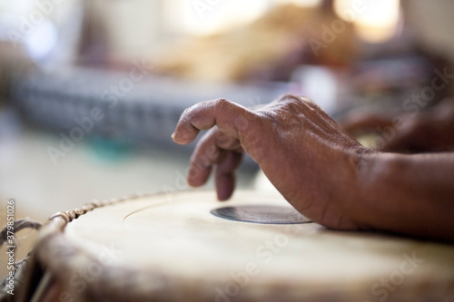 Man playing on traditional Indian tabla drums close up photo