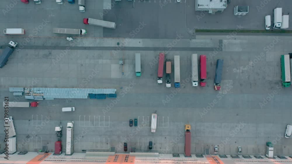 Many trucks getting loaded with freight at warehouse, goods delivery services Many trucks getting loaded with freight at warehouse, goods delivery services