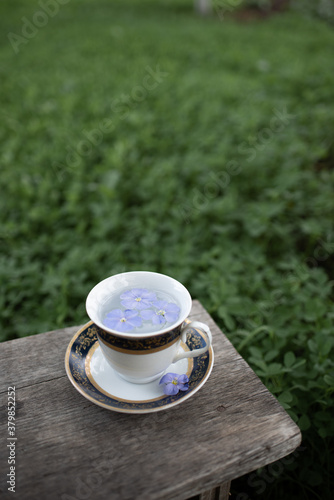 Vintage cup with saucer on a wooden bench, great design for any purposes.  Vintage style.