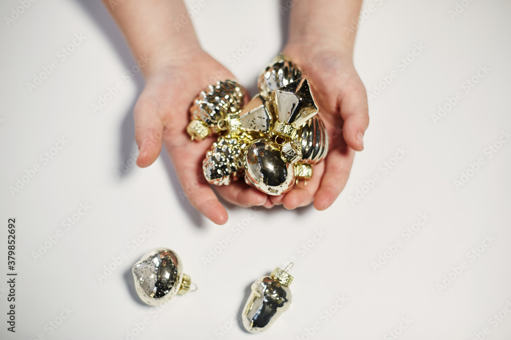 Hands holding gold baubles Hands holding gold baubles