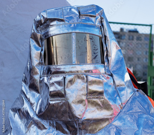 protective suit with mask, silver color for protection from hazardous substances and materials during disasters. Special suit, protective clothing for firefighters. Natural disasters