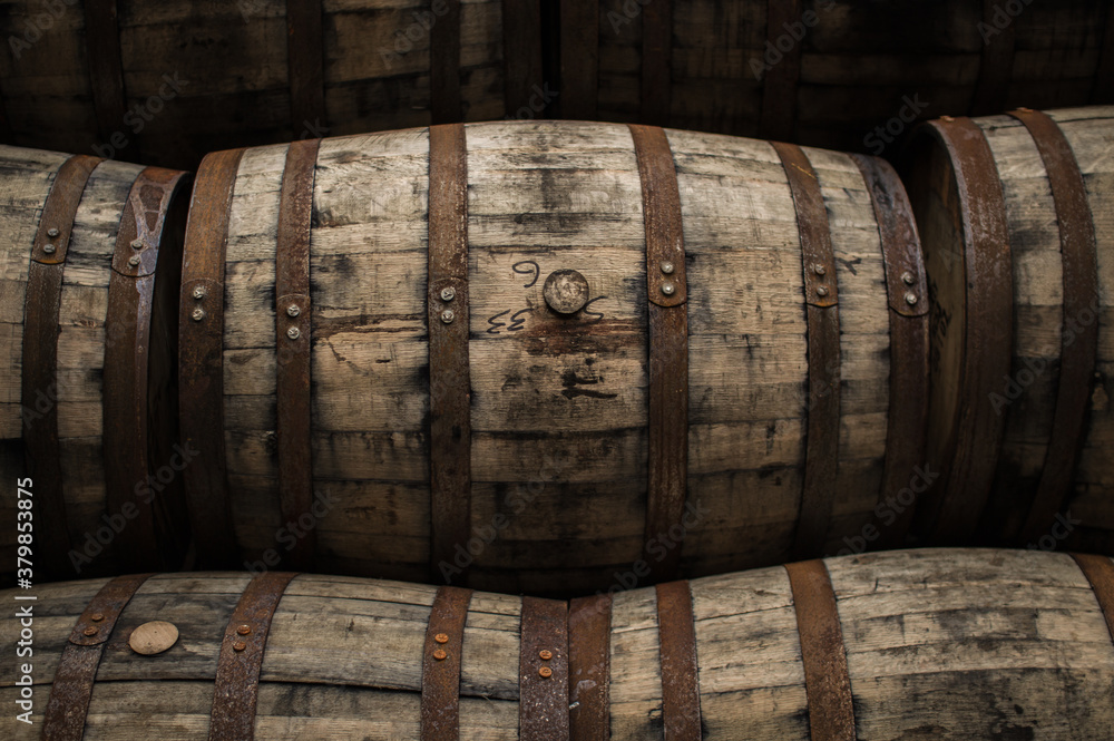 Wooden barrels and casks sit in a pile Wooden barrels and casks sit in a pile